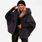 Women's oversized hooded quilted jacket with plush panels and ribbed cuffs