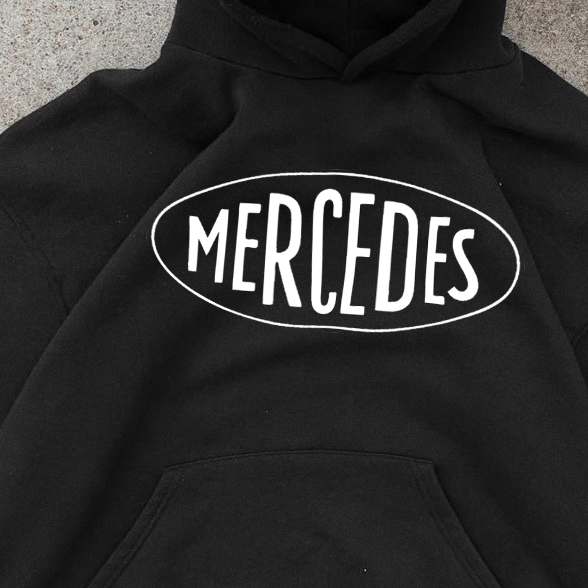 Black pullover hoodie with white Mercedes chest graphic and kangaroo pocket