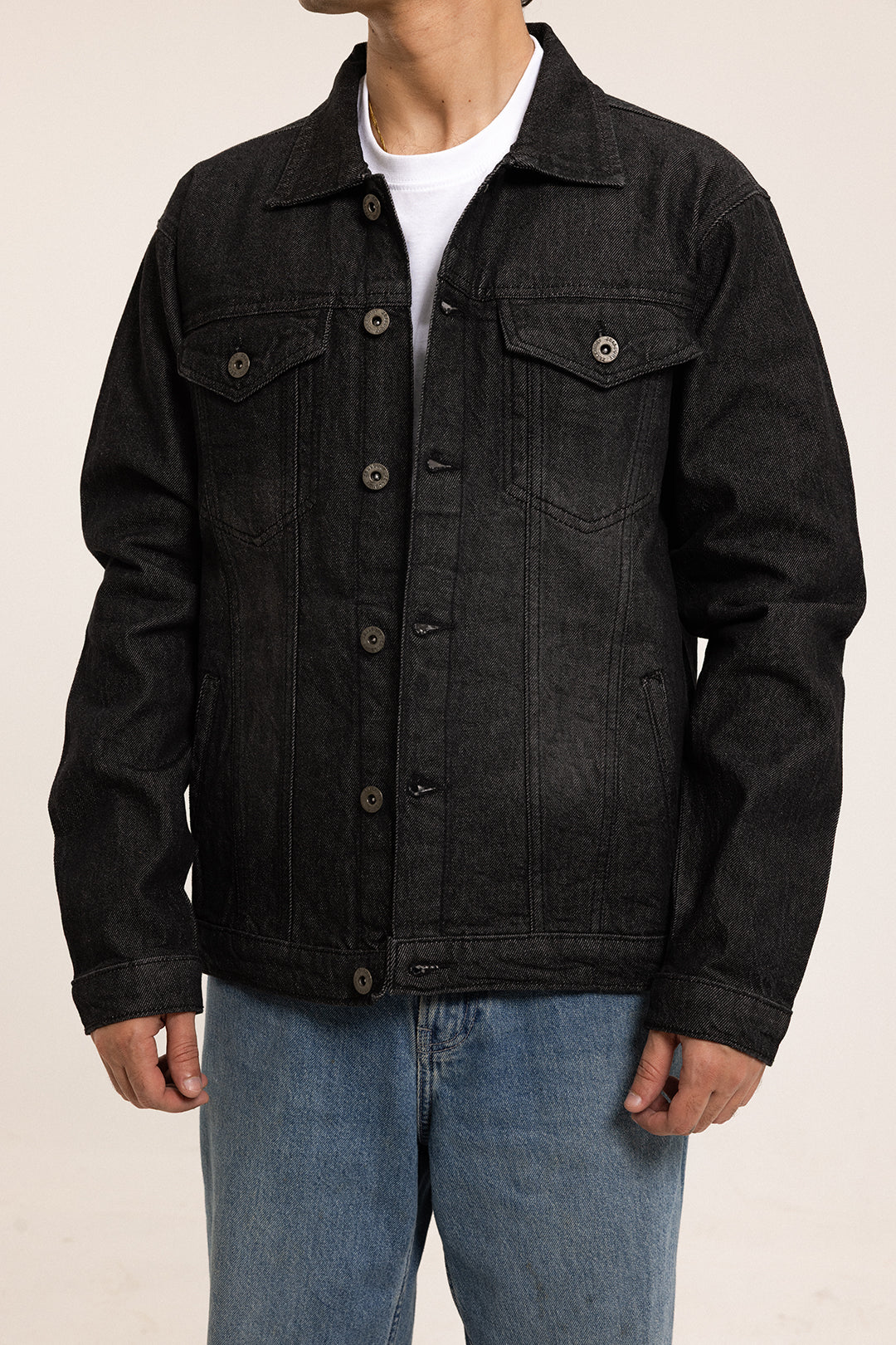 Men's black button-front utility jacket with pointed collar and flap pockets