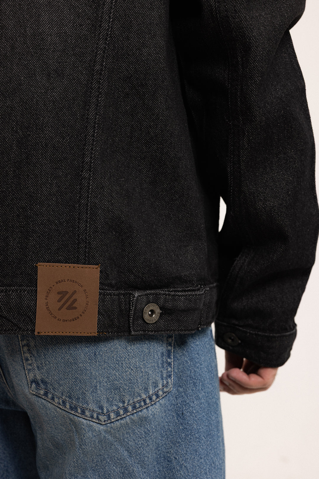 Men's black button-front utility jacket with pointed collar and flap pockets