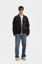 Men's black button-front utility jacket with pointed collar and flap pockets