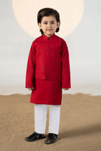 Child wearing a red traditional kurta suit set with matching trousers