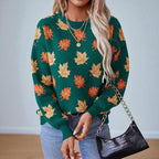 Women's crew neck sweater with repeated maple leaf pattern and long sleeves