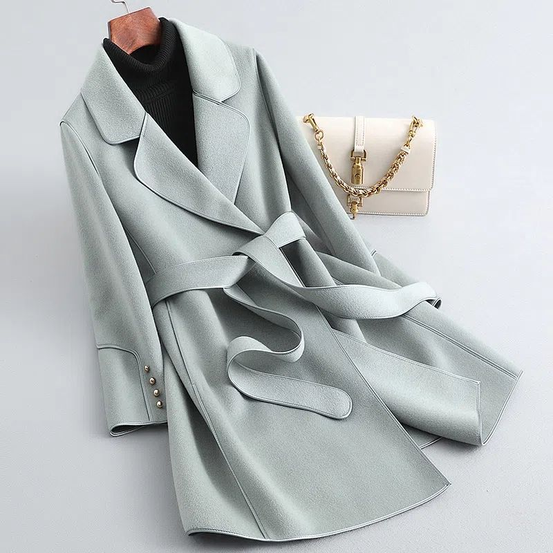 Women's belted trench coat with notched lapels, contrast piping and long sleeves