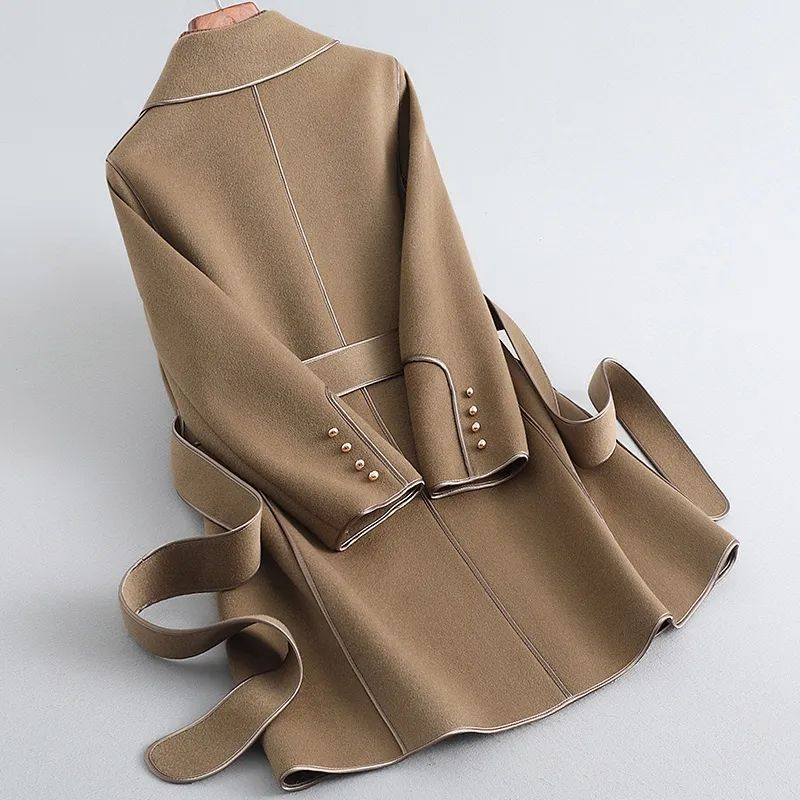 Women's belted trench coat with notched lapels, contrast piping and long sleeves