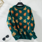 Women's crew neck sweater with repeated maple leaf pattern and long sleeves