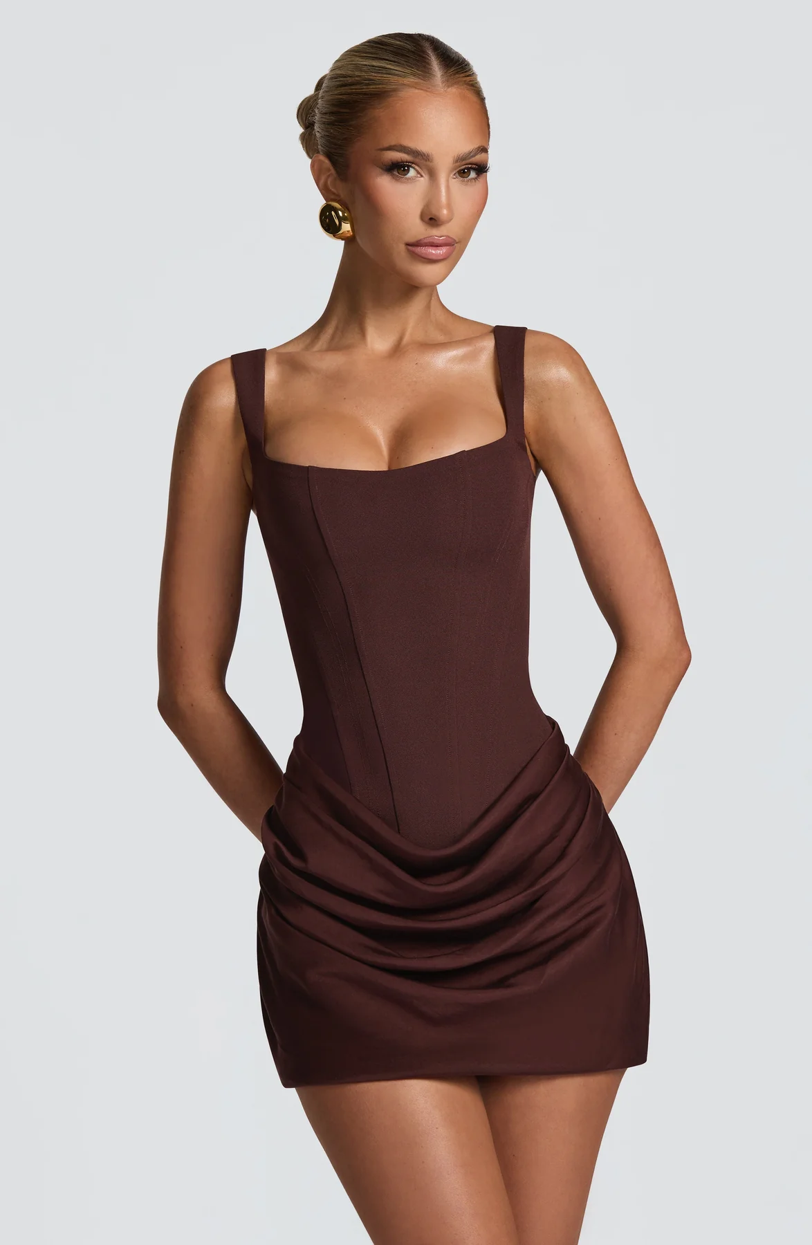 Women's sleeveless square-neck mini dress with a fitted bodice and draped ruched skirt