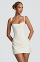 Women's sleeveless square-neck mini dress with a fitted bodice and draped ruched skirt