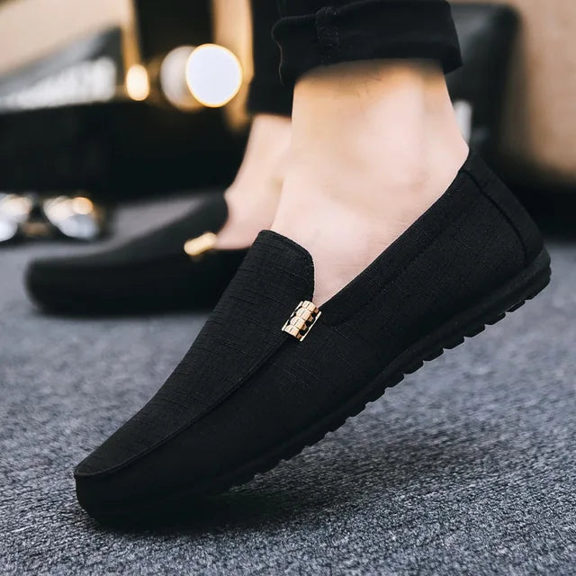 Men's slip-on loafers with gold-tone metal detail and flat sole