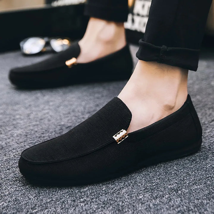Men's slip-on loafers with gold-tone metal detail and flat sole