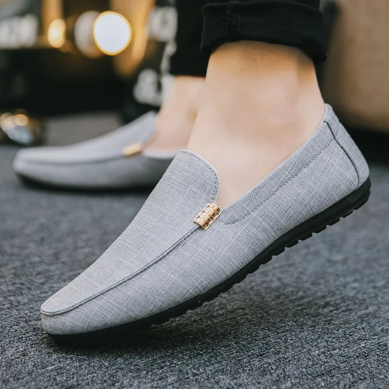 Men's slip-on loafers with gold-tone metal detail and flat sole