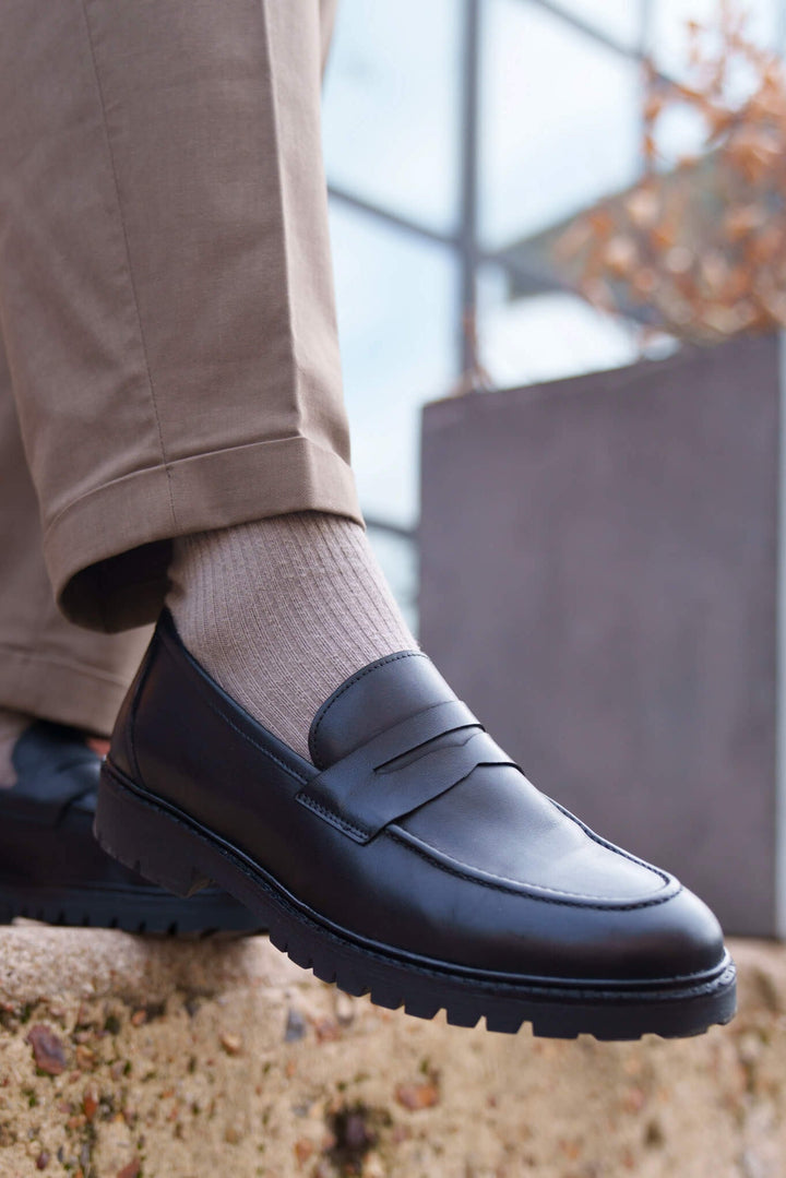 Men's black penny loafers with a chunky lug sole