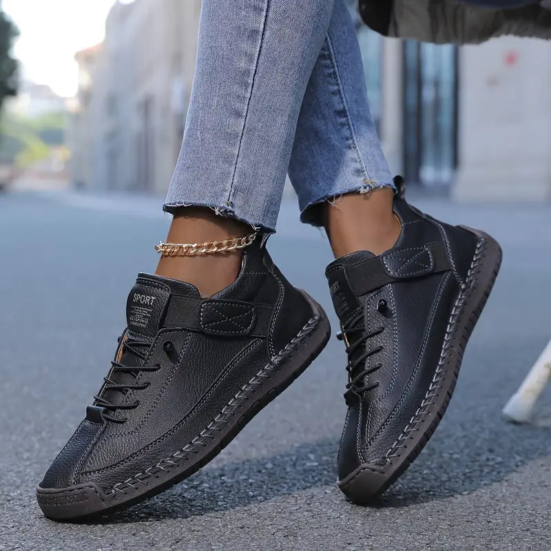 Women's ankle-collar lace-up sneakers with stitched panels and textured flat soles