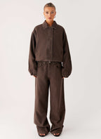 Women's brown washed denim bomber jacket with shirt collar and zip pockets