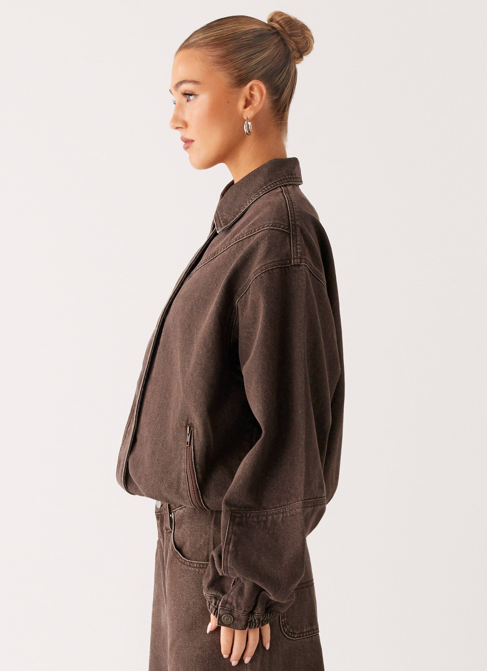 Women's brown washed denim bomber jacket with shirt collar and zip pockets