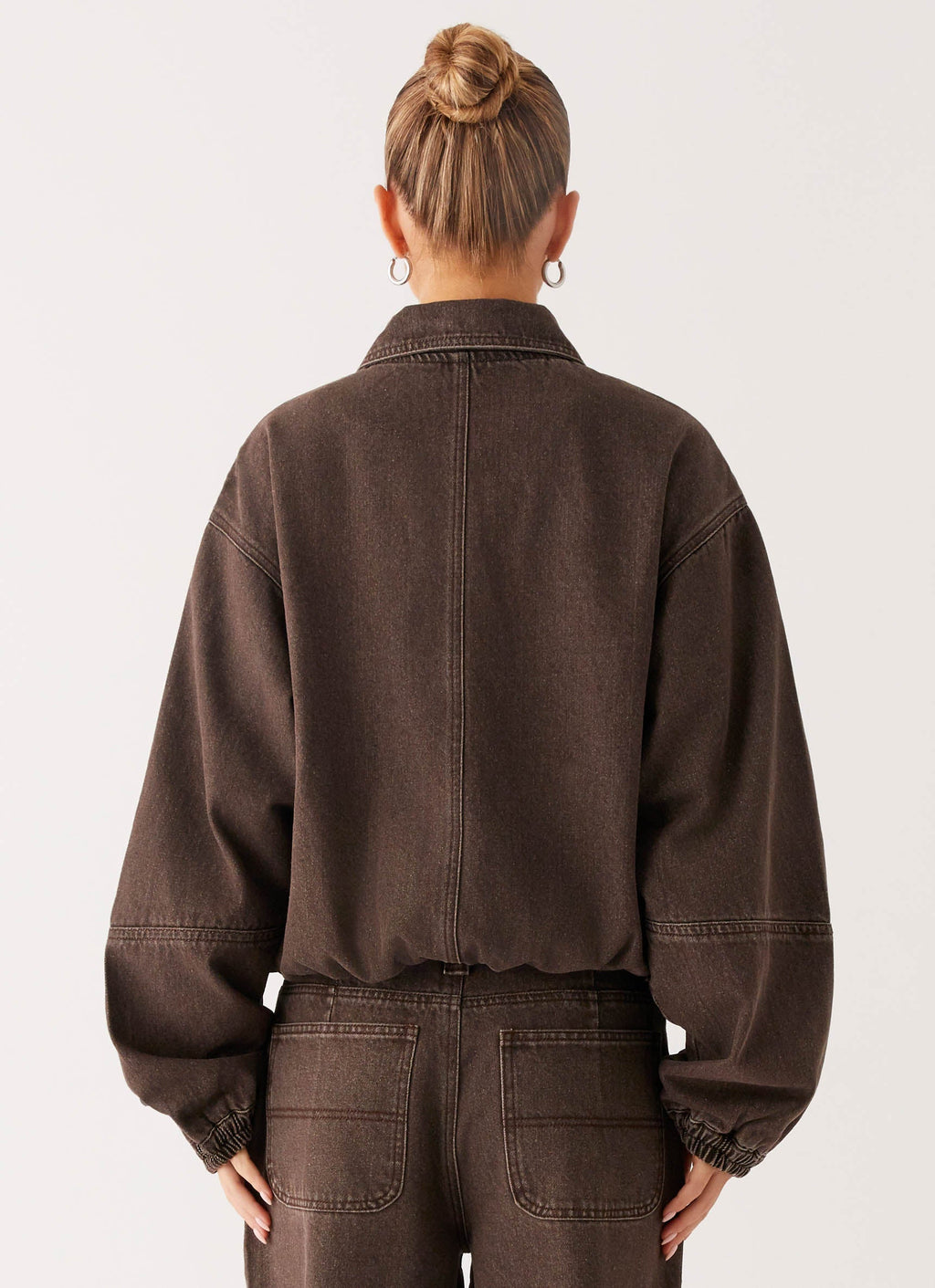Women's brown washed denim bomber jacket with shirt collar and zip pockets