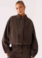 Women's brown washed denim bomber jacket with shirt collar and zip pockets