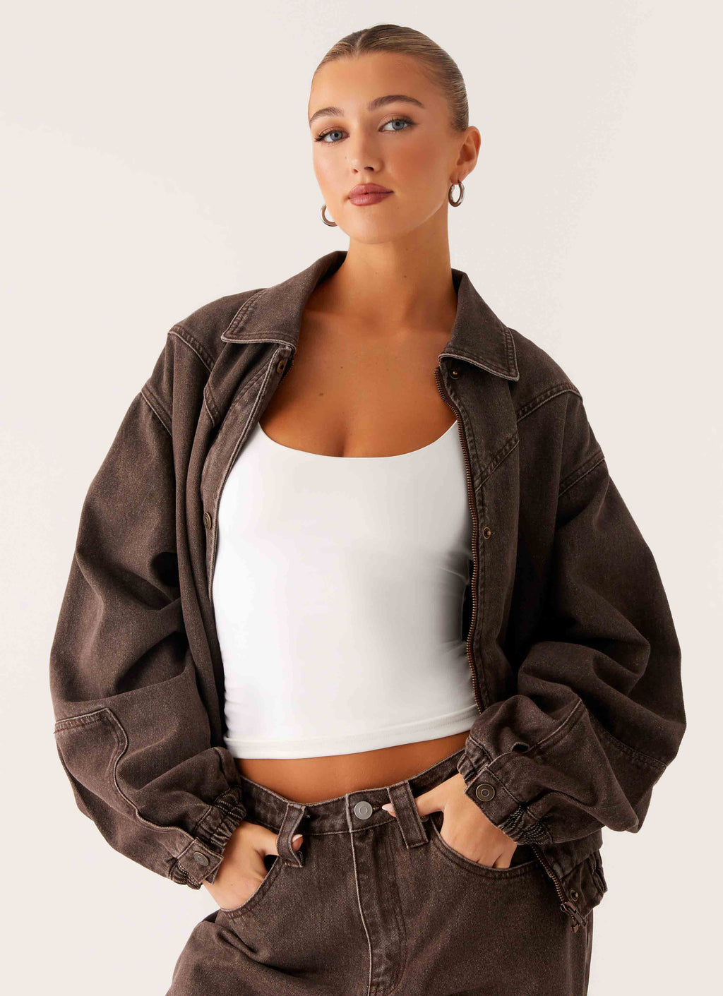 Women's brown washed denim bomber jacket with shirt collar and zip pockets