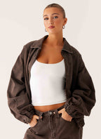 Women's brown washed denim bomber jacket with shirt collar and zip pockets