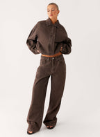 Women's brown washed denim bomber jacket with shirt collar and zip pockets