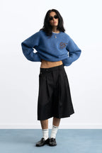 Women's blue crew-neck knit sweater with chest emblem
