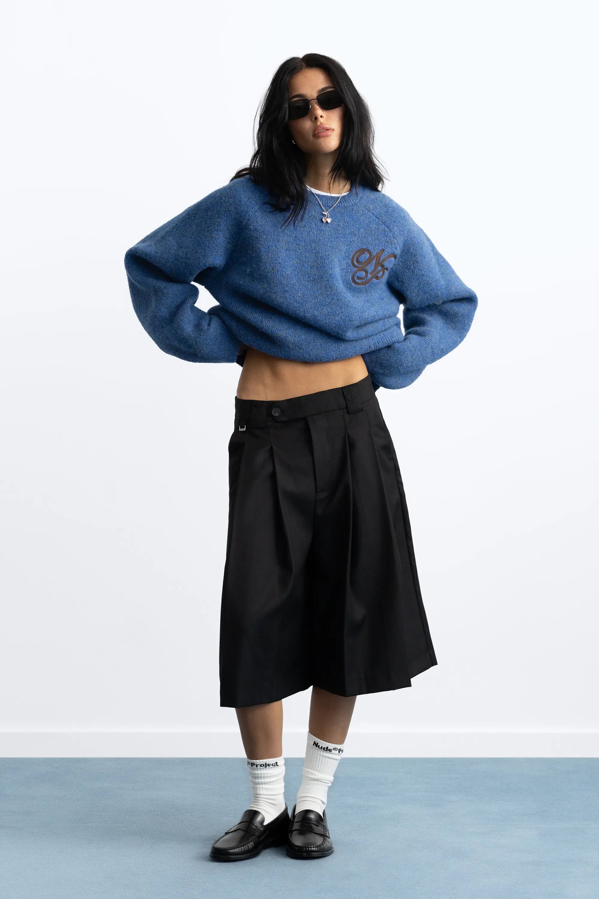 Women's blue crew-neck knit sweater with chest emblem