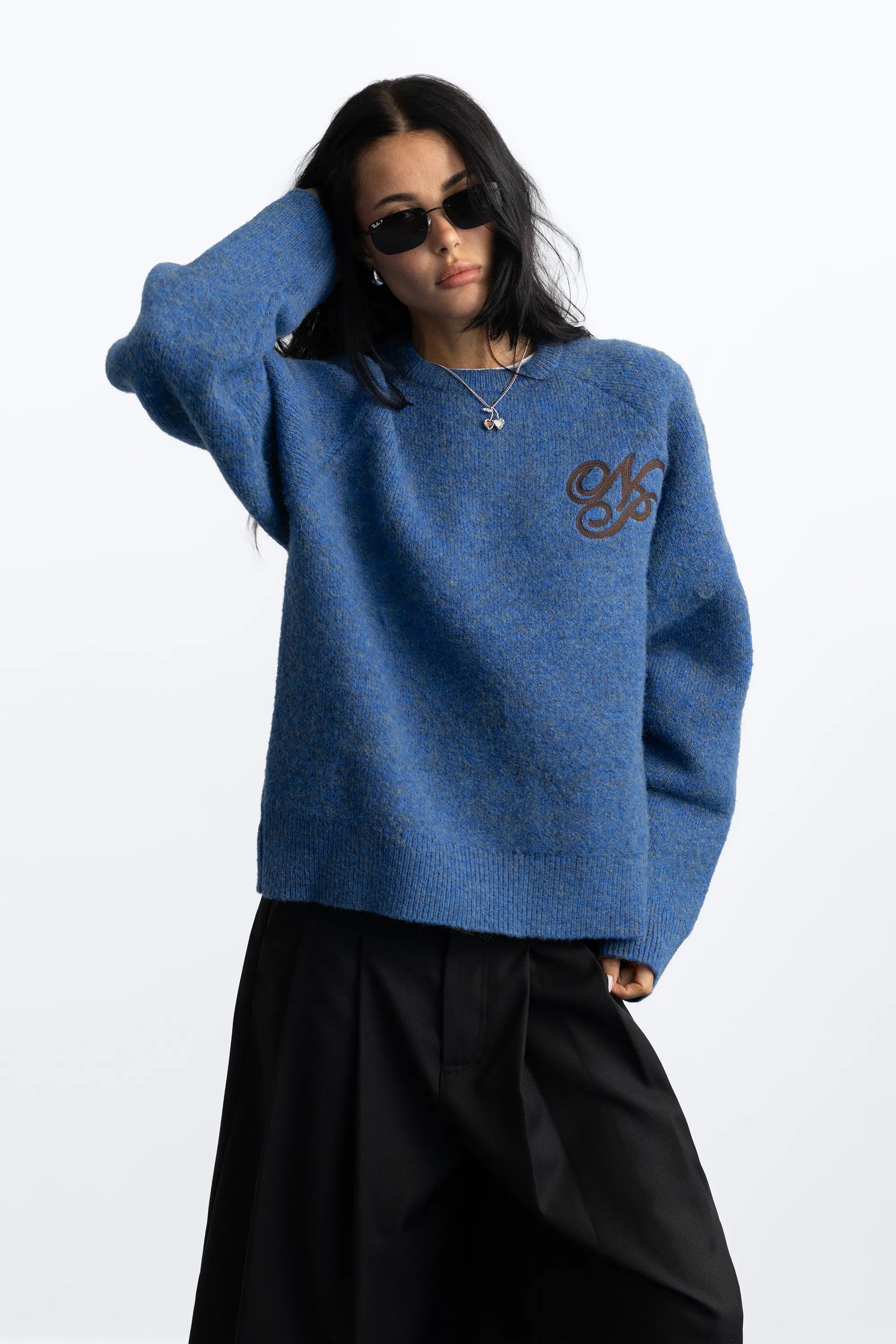Women's blue crew-neck knit sweater with chest emblem