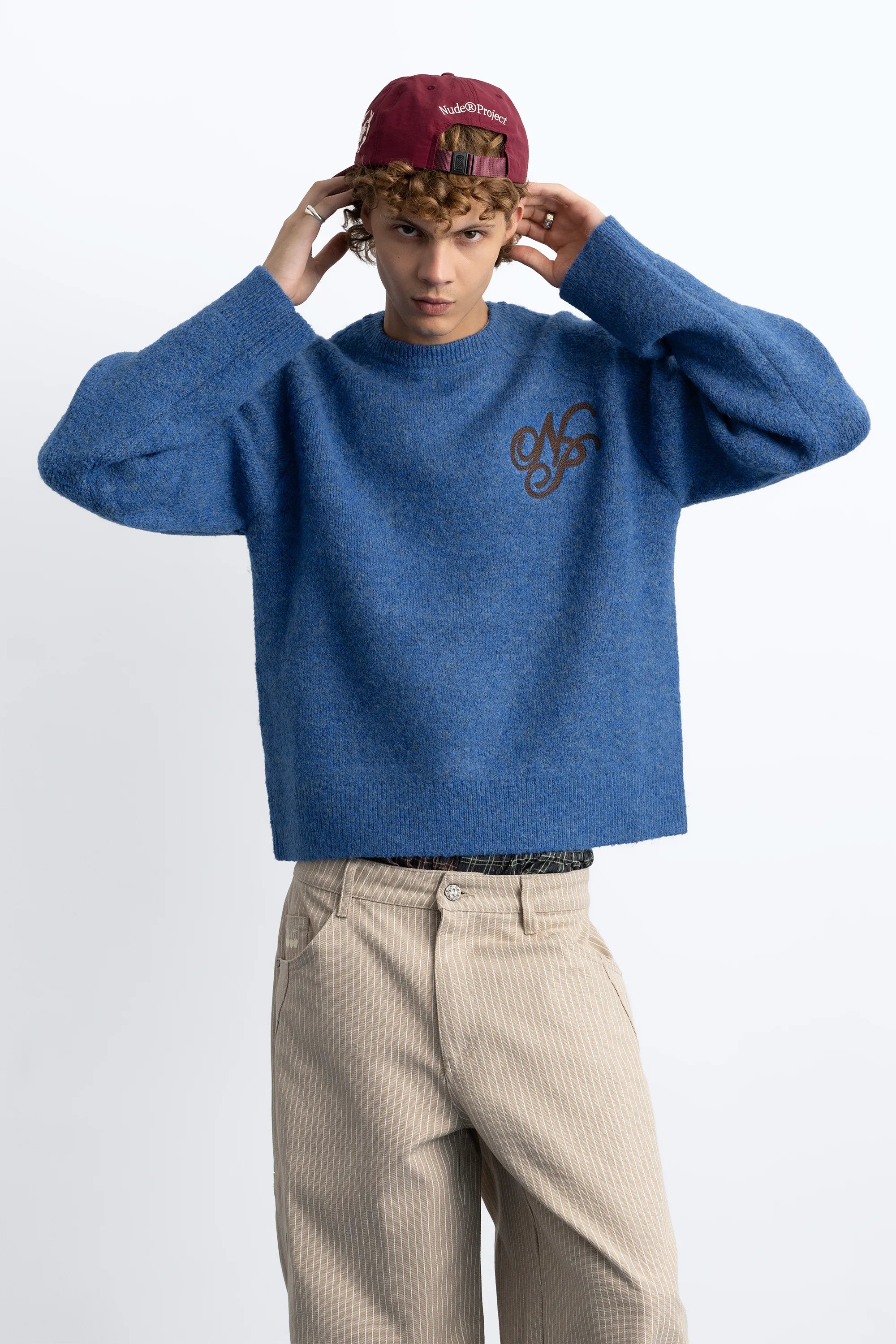 Women's blue crew-neck knit sweater with chest emblem