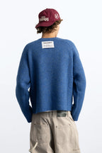 Women's blue crew-neck knit sweater with chest emblem