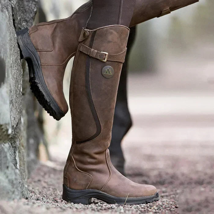 Women's tall winter boots with buckle strap and flat sole
