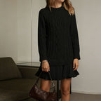 Women's long-sleeve cable knit sweater with a crew neckline and ribbed trims
