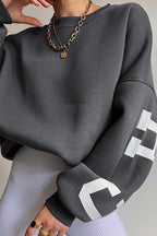Women's crew-neck sweatshirt with contrasting letter graphics on the sleeves