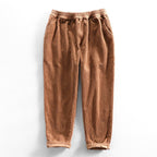 Unisex ribbed corduroy trousers with elasticated waist, side pockets and turned-up hems