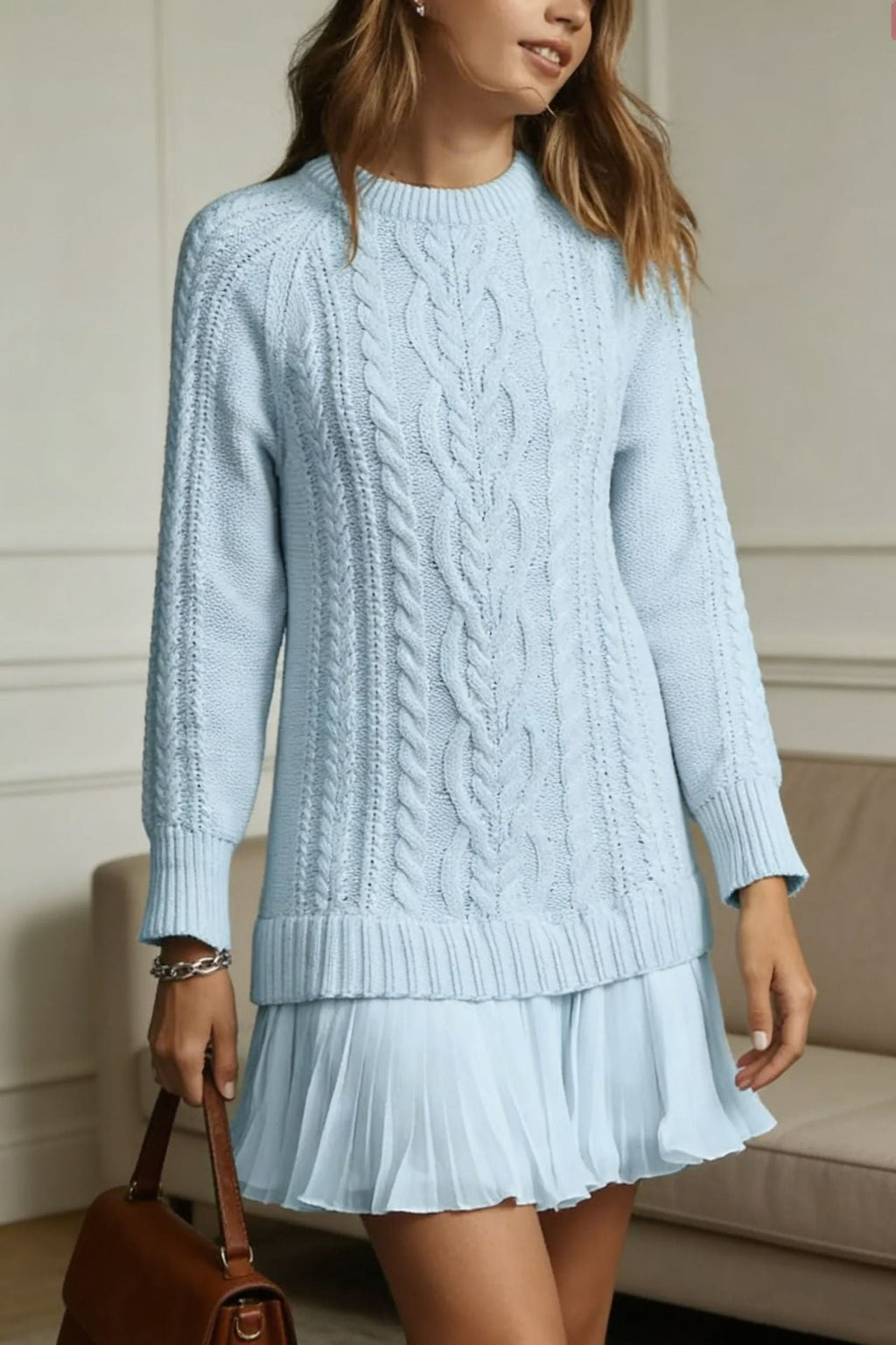 Women's long-sleeve cable knit sweater with a crew neckline and ribbed trims