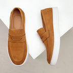 Men's penny loafers with moc toes, strap detail and white flat soles