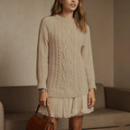 Women's long-sleeve cable knit sweater with a crew neckline and ribbed trims