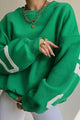 Women's crew-neck sweatshirt with contrasting letter graphics on the sleeves