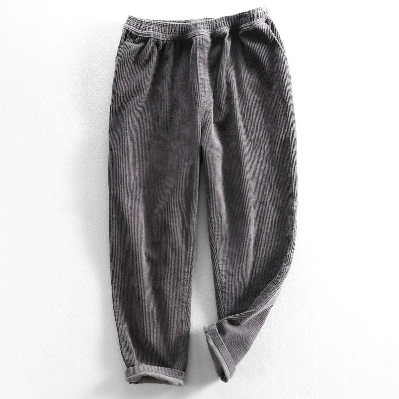 Unisex ribbed corduroy trousers with elasticated waist, side pockets and turned-up hems