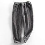 Unisex ribbed corduroy trousers with elasticated waist, side pockets and turned-up hems
