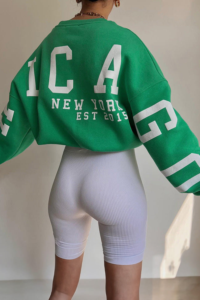 Women's crew-neck sweatshirt with contrasting letter graphics on the sleeves