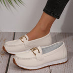 Women's flat loafers with decorative metal buckles and rounded toes