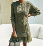 Women's long-sleeve cable knit sweater with a crew neckline and ribbed trims