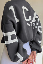 Women's crew-neck sweatshirt with contrasting letter graphics on the sleeves