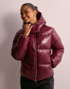 Women's shiny quilted hooded puffer jacket with leopard cuffs