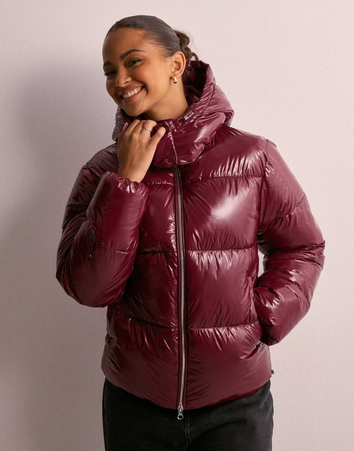 Women's shiny quilted hooded puffer jacket with leopard cuffs