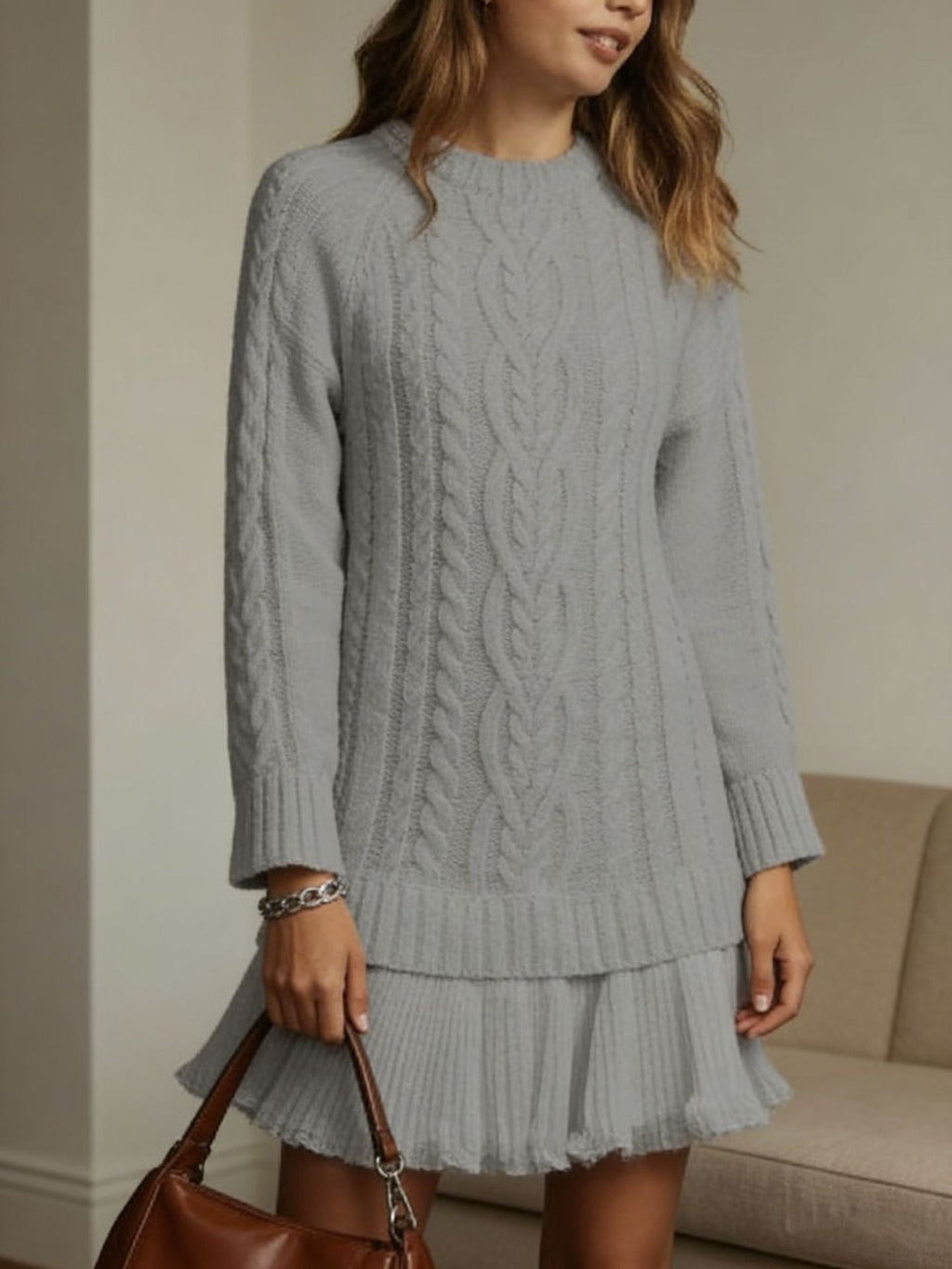 Women's long-sleeve cable knit sweater with a crew neckline and ribbed trims