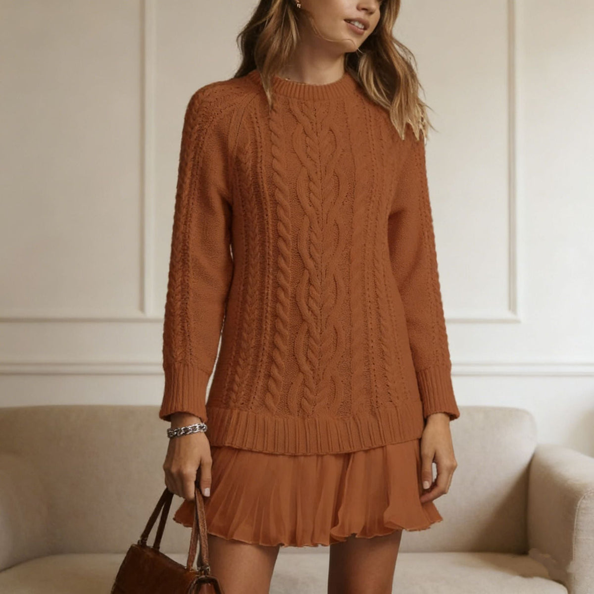 Women's long-sleeve cable knit sweater with a crew neckline and ribbed trims