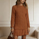 Women's long-sleeve cable knit sweater with a crew neckline and ribbed trims