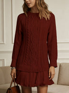 Women's long-sleeve cable knit sweater with a crew neckline and ribbed trims
