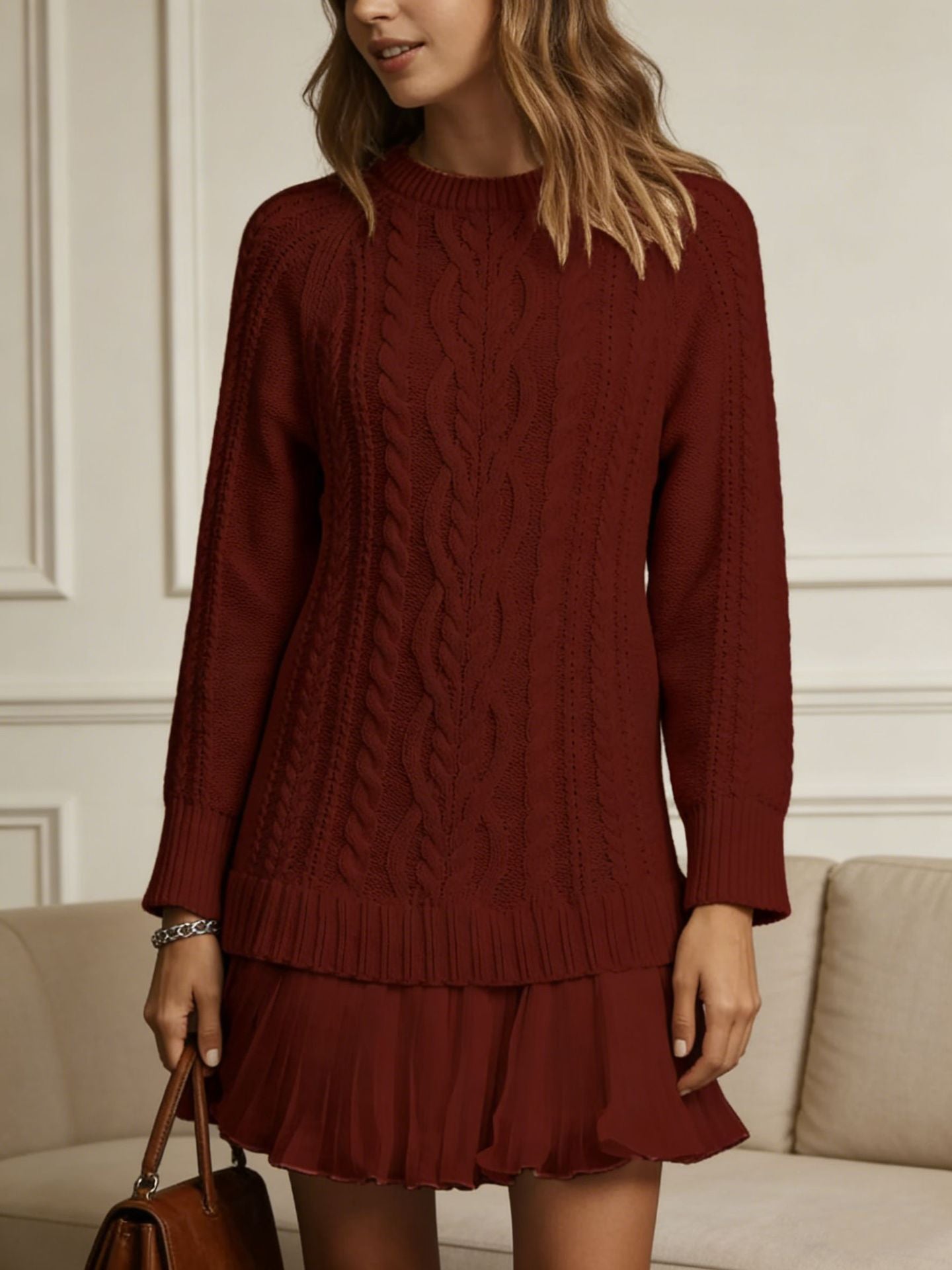 Women's long-sleeve cable knit sweater with a crew neckline and ribbed trims